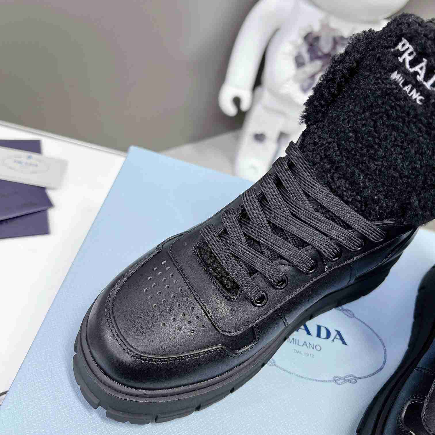 Prada Leather And Shearling High-top Sneakers - PerfectKickZ